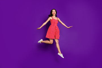 Full length body size view of her she nice attractive lovely cheerful cheery wavy-haired girl jumping having fun strolling isolated on bright vivid shine vibrant lilac purple violet background