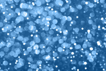 Blue festive background with sparkles in the bokeh. The concept of the celebration, the day of Christmas, New Year, birthday, ceremonies, events, etc.