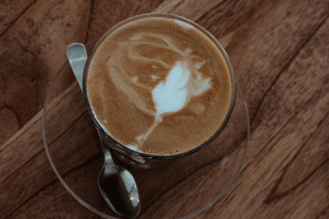 cup of coffee on wooden table