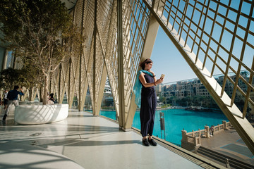 Beautiful young woman in a long dark dress takes a selfie