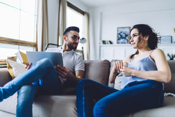Cheerful couple chilling at home together
