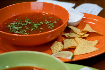 hot tasty delicious rustic homemade american pizza with tomato gherkin salami olives with thick crust on black table