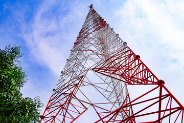 High voltage electric, Signaling, Communication pole on sky background.