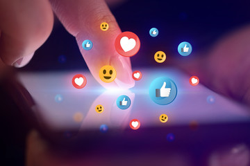 Finger touching phone with social media concept and dark background