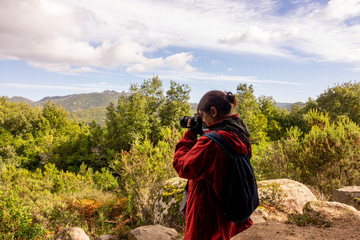 Woman tourist photographer on a mountain.