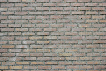Standard light yellowish and reddish brick wall background texture