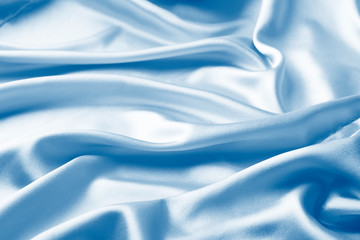 Fototapeta premium Background in satin pink fabric draped in classic blue waves. Trend monochrome tinting. Copy space of horizontal frame.