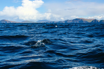 Panorama of the Irish coastline take from a small boat at the Atlantic ocean waves and sky, Ireland