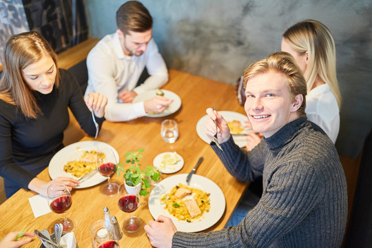 Group of young people having lunch in the restaurant