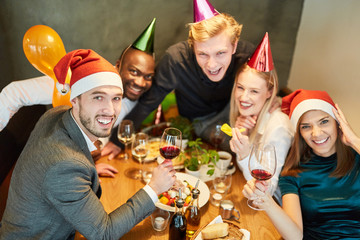 Group of friends celebrates exuberantly in the restaurant