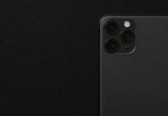 Close up photo of modern smartphone with triple lens camera