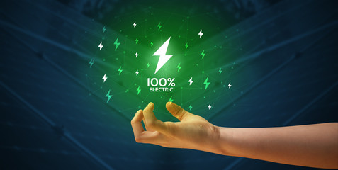 Hand in suit holding lightning bolt on his hand, green environment concept