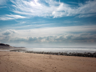 Fototapeta na wymiar Beautiful clouds over Strandhill sandy beach, county Sligo, Low tide, Calm and peaceful scene. Ireland. Atlantic ocean,