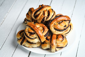 Homemade buns with dark chocolate on a  light rustic  background copy space.