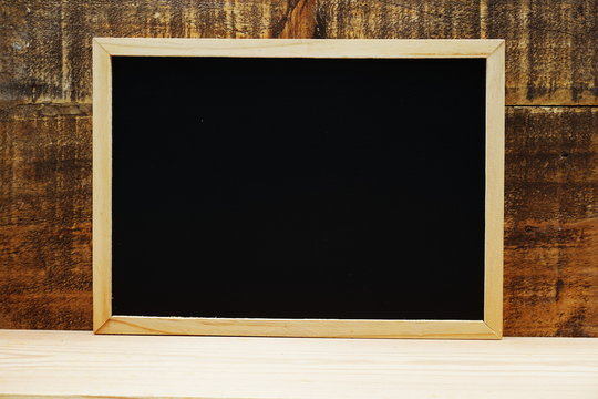 Empty space of black board on wooden background