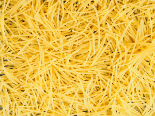 Background of little yellow pasta. Healthy eating concept