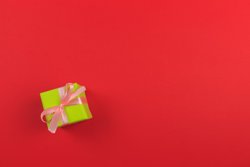 Gift box with ribbon and bow on color background and space for text. Top view - Image