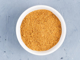 Spice masala in a white bowl on a gray concrete background. Healthy eating concept