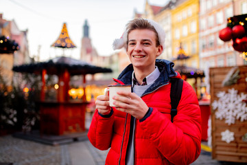 Young boy with drink on Christmas market in Wroclaw, Poland