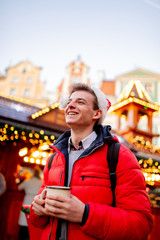 Young boy with drink on Christmas market in Wroclaw, Poland