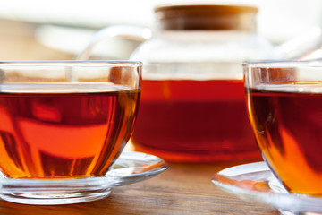 Hot cup of tea on wooden rustic table close up