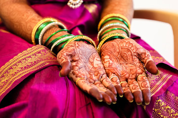 Beautiful Indian bride hand with mehandi design and jewelry 