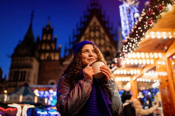 Young girl with drink on Christmas market in Wroclaw, Poland