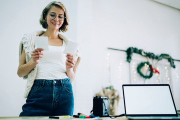 Attractive woman looking at photos on hands