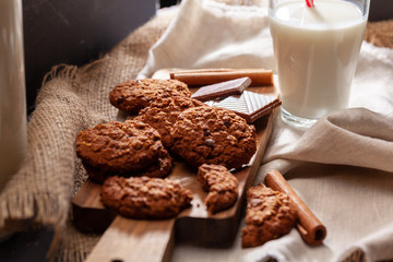 Chocolate crispy cookies with glass of milk close up