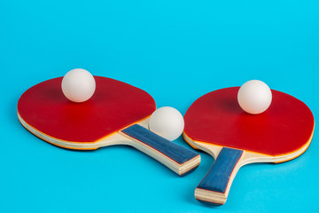 Red ping pong racket on a blue background
