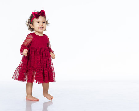 Child 2 Years Old Girl In A Red Dress Isolate White Background Dancing Smiling Pretty Beautiful In A Bow Festive Outfit Birthday New Year Christmas