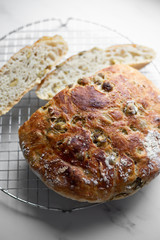 Loaf of home made artisan bread  with olive. still life