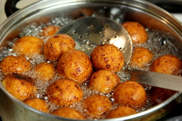 Cottage cheese balls. Small balls of freshly baked homemade cottage cheese fried hot oil. Freshly made donuts from cottage cheese