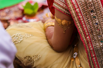 Traditional indian wedding ceremony in Hinduism : golden Bracelet  on hand    