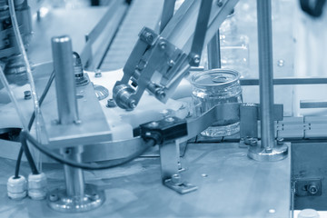 The can packaging manufacturing process in the light blue scene. The modern technology for automatic packaging process control by computer system.