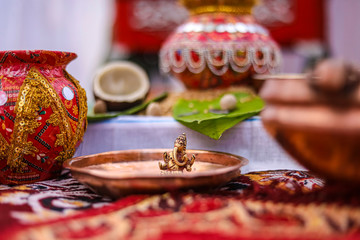 Indian wedding ceremony : decorative coper kalash with green leaf and coconut 
