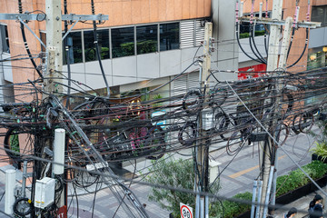 Bangkok, Thailand - Chaos of power lines on utility poles in downtown Bangkok provide electricity to the city