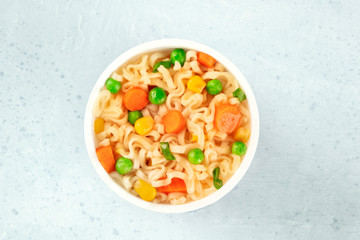 Instant noodles with vegetables in a plastic cup, shot form the top