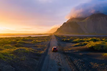 Door stickers Atlantic Ocean Road Gravel road at sunset with Vestrahorn mountain and a car driving, Iceland