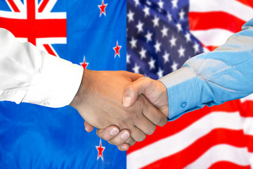 Business handshake on the background of two flags. Men handshake on the background of the New Zealand and United States of America flag. Support concept