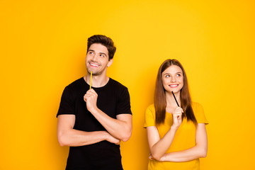Photo of cheerful positive cute nice charming couple of two people pondering over surprise for each other isolated over vivid color background in black t-shirt - Powered by Adobe
