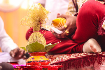 Traditional indian wedding ceremony:  coconut in decorative coper kalash 