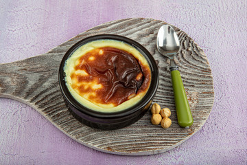 Delicious rice pudding with cinnamon in bowl on wooden background
