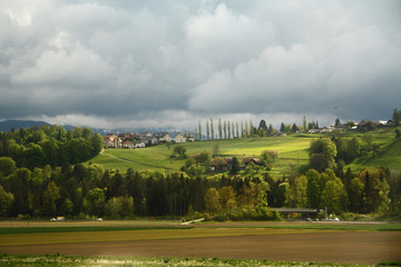 A Spring Landscape in Switzerland with Forest and a Village