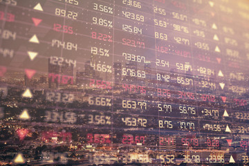 Fototapeta premium Financial graph on night city scape with tall buildings background double exposure. Analysis concept.