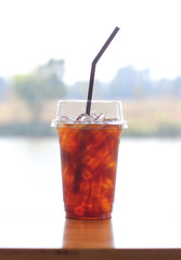 Black coffee with ice on table in cafe.