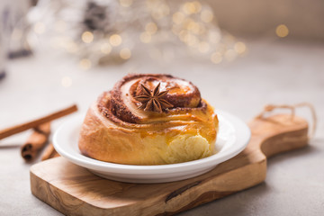 Confectionery baking. Sweet fresh soft roll bun with cinnamon on concrete background.  Christmas  food recipe