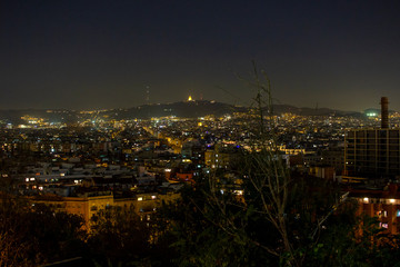 view of the lights of the city of Barcelona at night viewed from Montjuic