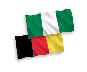 National vector fabric wave flags of Nigeria and Belgium isolated on white background. 1 to 2 proportion.