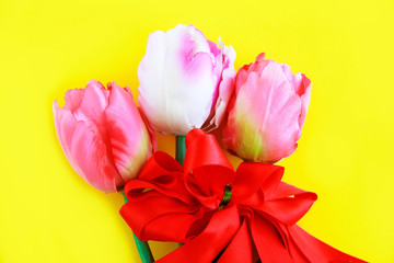 festive bouquet of natural pink tulips with a red ribbon